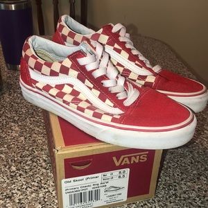 Red checkered board lace up vans .